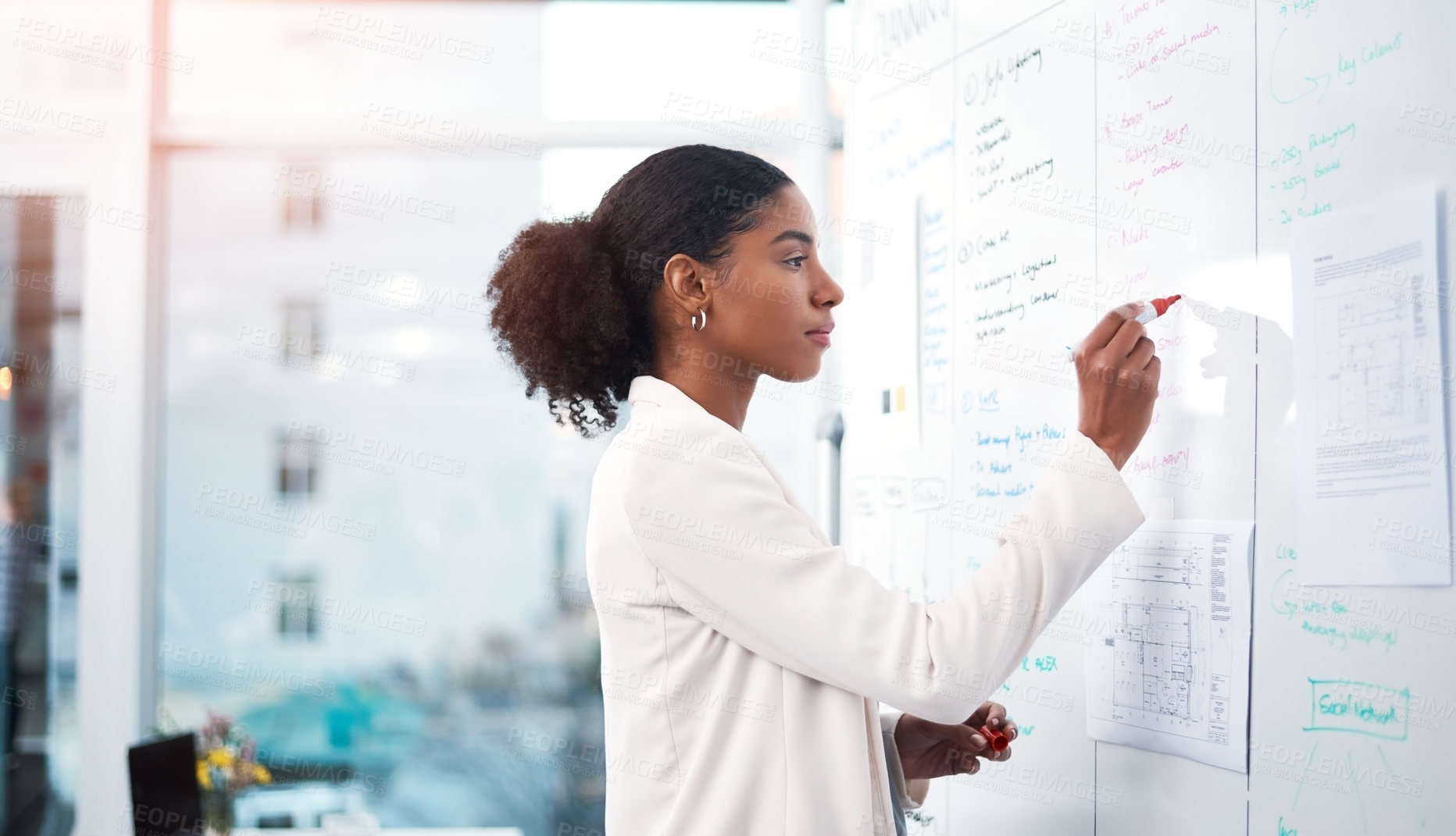 Buy stock photo Businesswoman planning marketing strategy on a whiteboard in modern office for a corporate company. Serious, focused and professional African female writing a smart and creative idea at the workplace