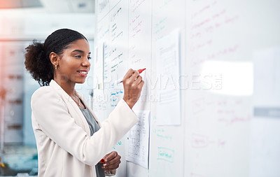 Buy stock photo Project manager writing on a whiteboard to plan ideas and visualize business strategy. Focused, confident and thoughtful businesswoman showing ambition and dedication while working in an office

