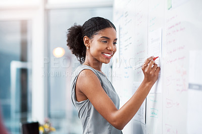 Buy stock photo Businesswoman and project manager planning a marketing strategy and brainstorming ideas on a whiteboard during her presentation. Entrepreneur and leader preparing notes and plan to achieve success