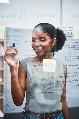 Buy stock photo Project manager writing on a whiteboard to plan ideas and visualize business strategy. Focused, confident and thoughtful businesswoman showing ambition and dedication while working in an office