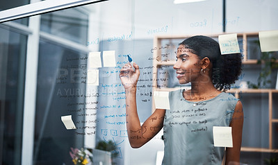 Buy stock photo Female leadership and marketing professional brainstorming innovation ideas, writing on transparent board with sticky notes in office. Young entrepreneur planning business mission and strategy.