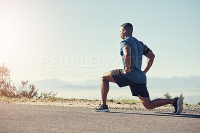 Buy stock photo Shot of a young handsome man doing lunges outdoors