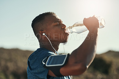 Buy stock photo Black man, drink water and music in outdoors for running, thirst and hydrate on sports break. Person, profile and mineral liquid in bottle for nutrition, athlete and phone app for streaming song