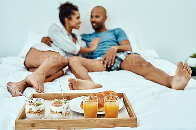 Buy stock photo Shot of a couple having breakfast in bed