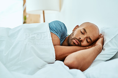 Buy stock photo Relax, sleeping and man in bed, home and wellness with peace, comfortable or happiness. Male person, African or guy in a bedroom, healthy rest or dreaming with comfort, sleepy or tired with a blanket