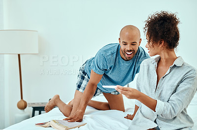 Buy stock photo Shot of a young couple taking a home pregnancy test