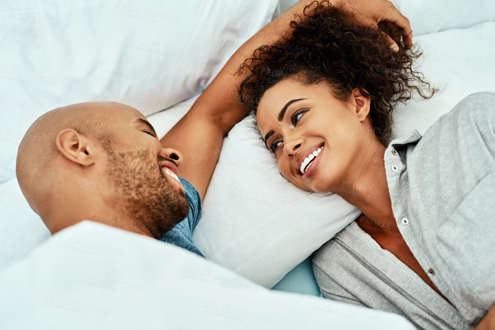 Buy stock photo Smile, couple and relax with love in bedroom for romantic connection, marriage and bonding together. Man, woman and relaxing with affection at home for loyalty, commitment and resting on weekend