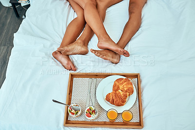 Buy stock photo Shot of a couple having breakfast in bed
