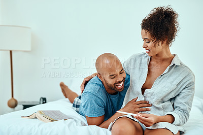 Buy stock photo Shot of a young couple taking a home pregnancy test