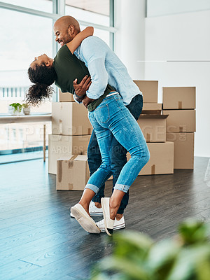 Buy stock photo Shot of a young couple celebrating the move into their new home