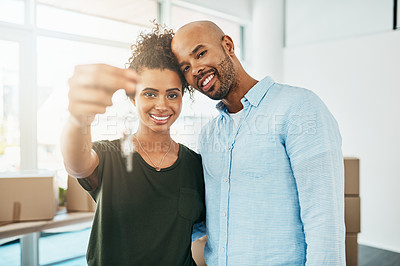 Buy stock photo Portrait of a young couple holding the keys to their new home