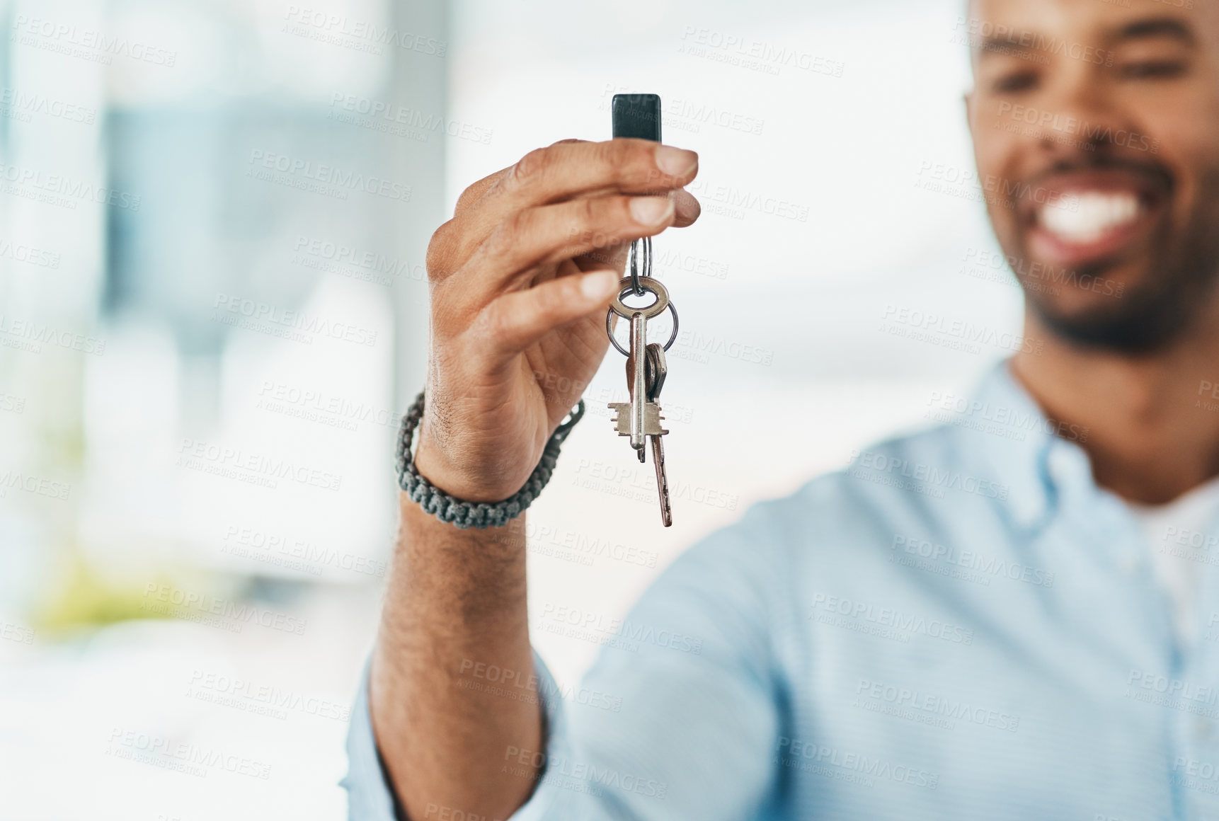 Buy stock photo Shot of a young man holding the keys to his new home