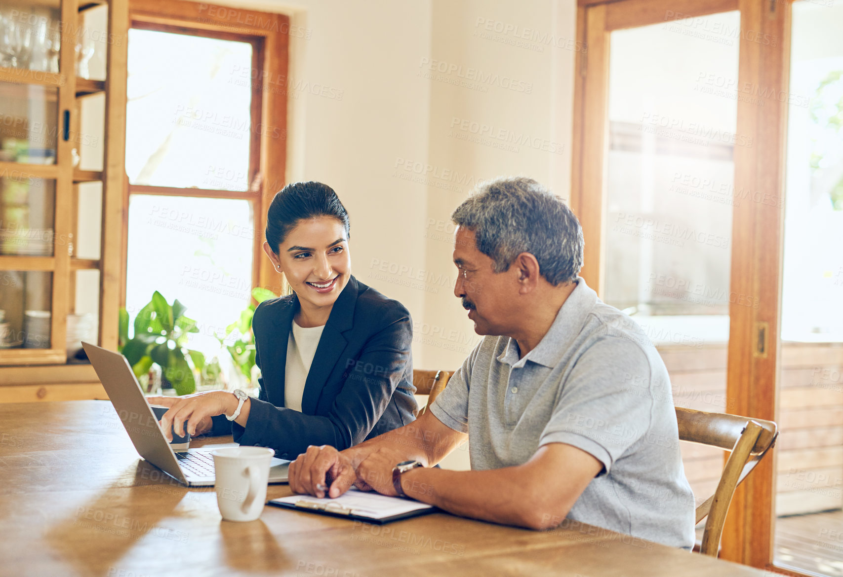 Buy stock photo Shot of a mature man getting advice from a financial consultant at home