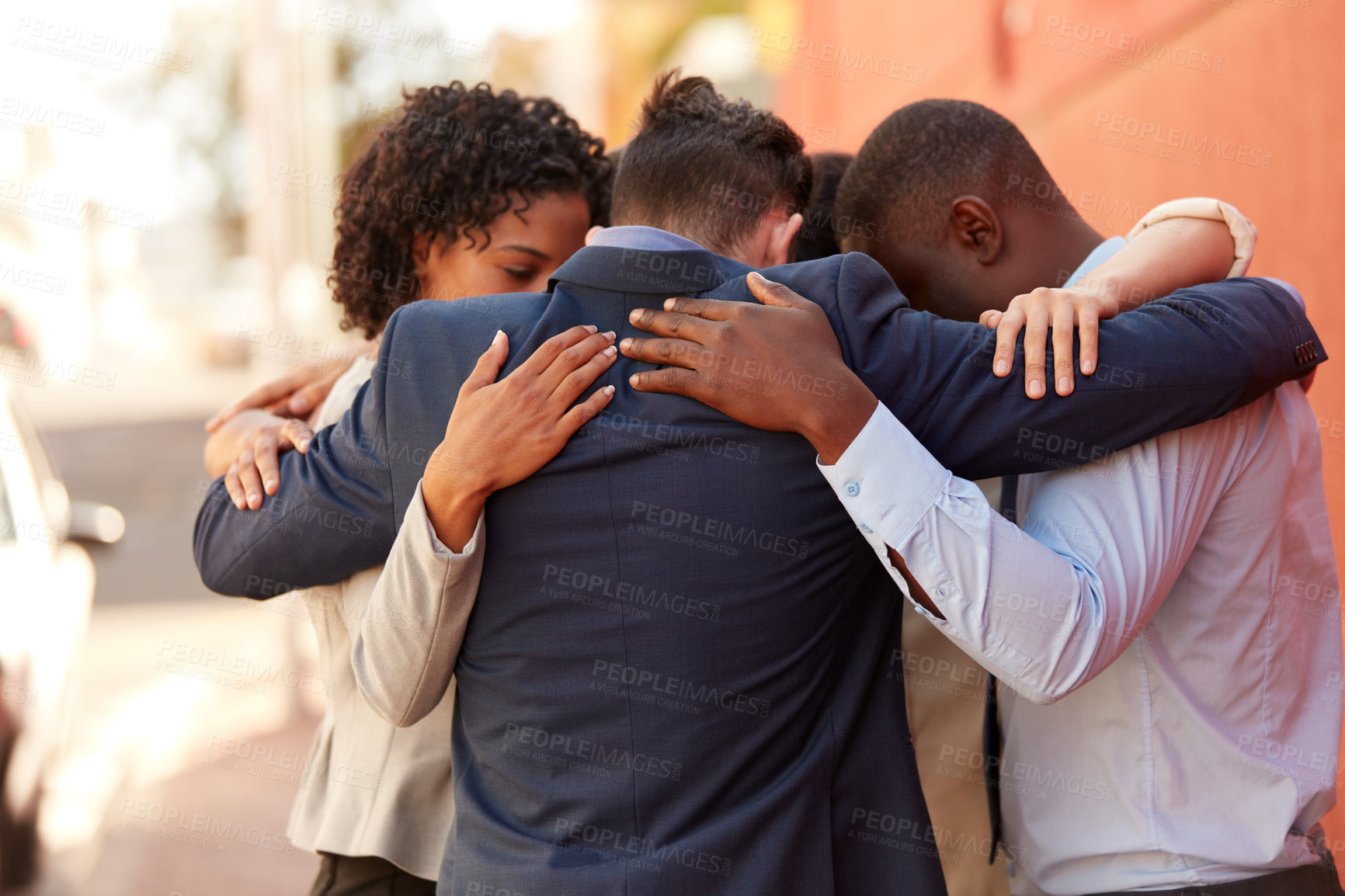 Buy stock photo Shot of a group of businesspeople standing together in a huddle outdoors