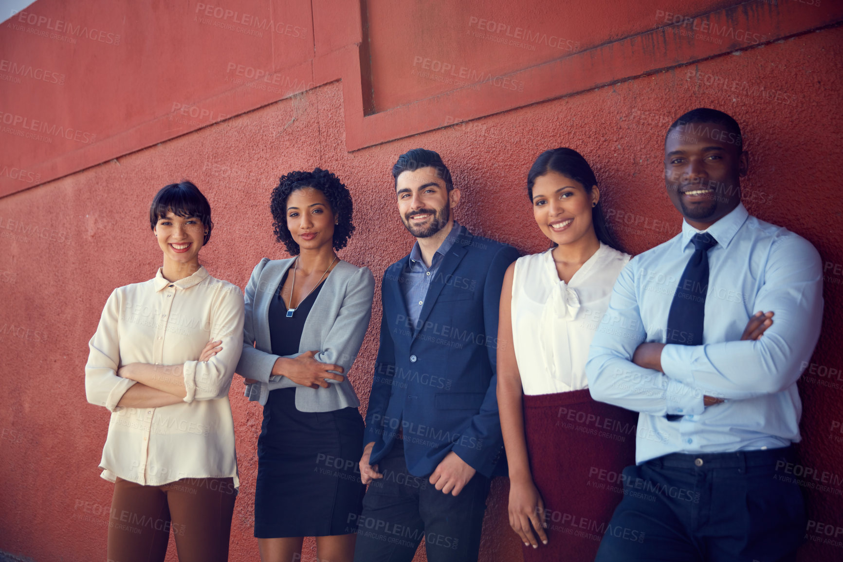 Buy stock photo Portrait of a group of businesspeople standing against a wall outdoors