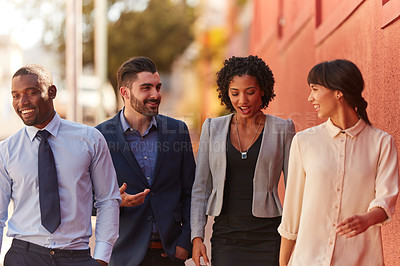 Buy stock photo Shot of a group of businesspeople walking in the city