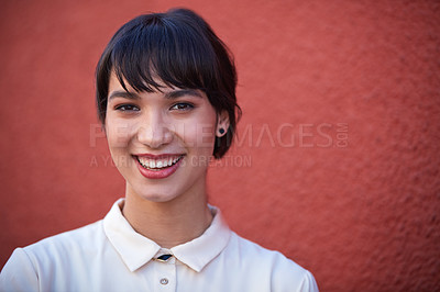 Buy stock photo Portrait of a young businesswoman standing against a red wall outdoors