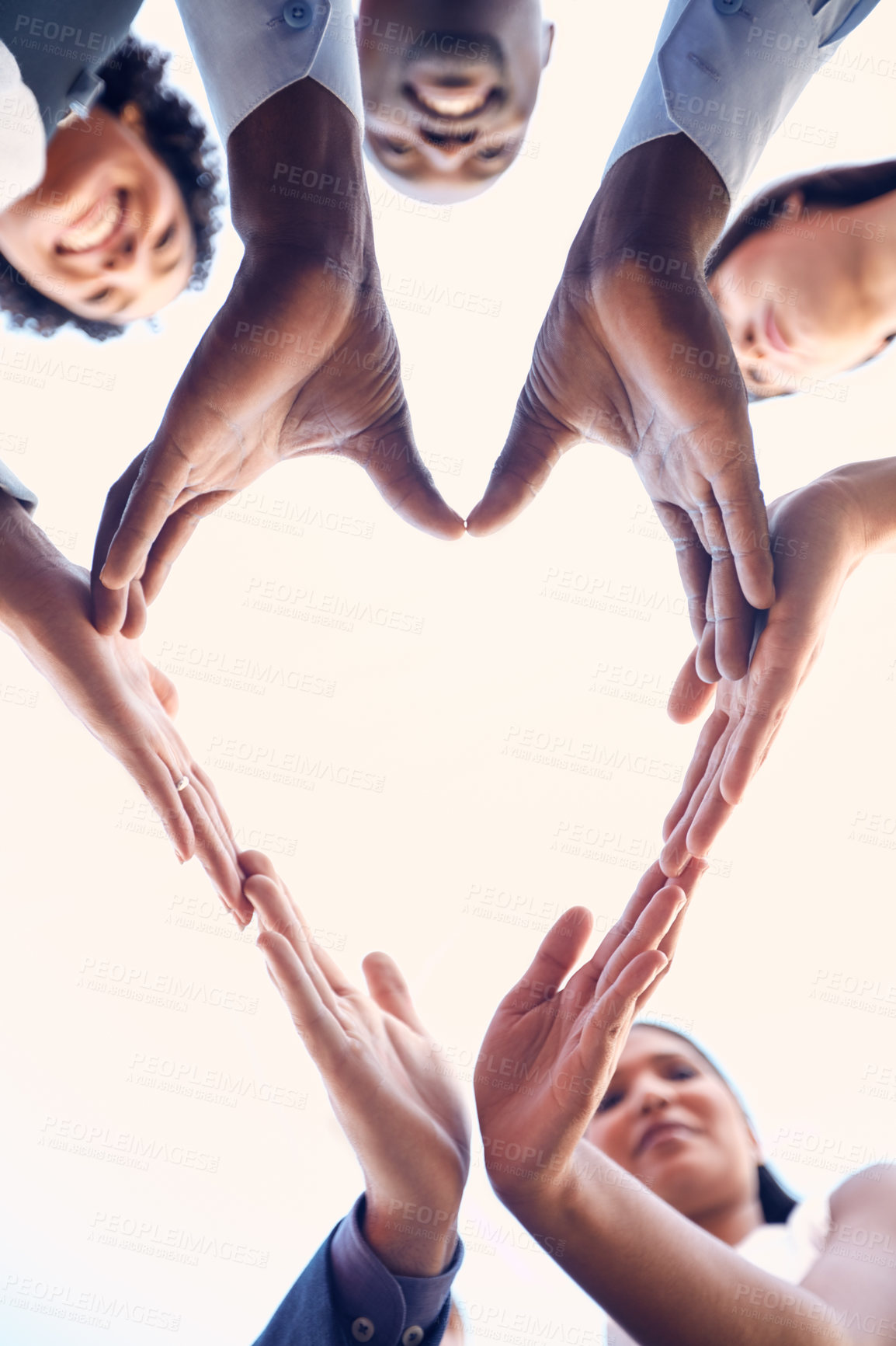 Buy stock photo Closeup shot of a group of unrecognizable businesspeople making a heart shape with their hands outdoors