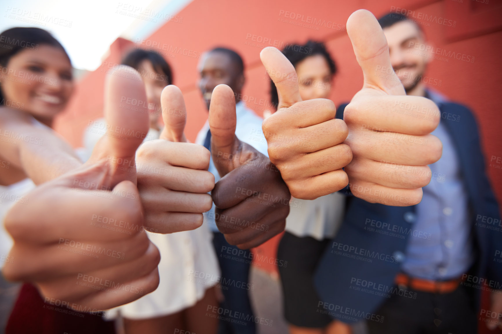 Buy stock photo Shot of a group of businesspeople showing thumbs up outdoors