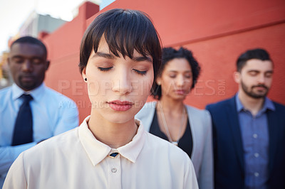 Buy stock photo Shot of a group of businesspeople standing with their eyes closed outdoors