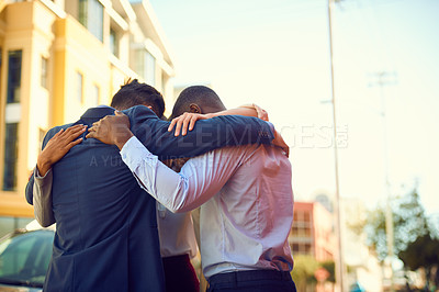 Buy stock photo Shot of a group of businesspeople standing together in a huddle outdoors