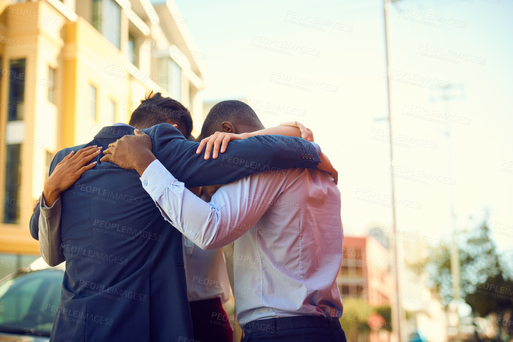 Buy stock photo Shot of a group of businesspeople standing together in a huddle outdoors