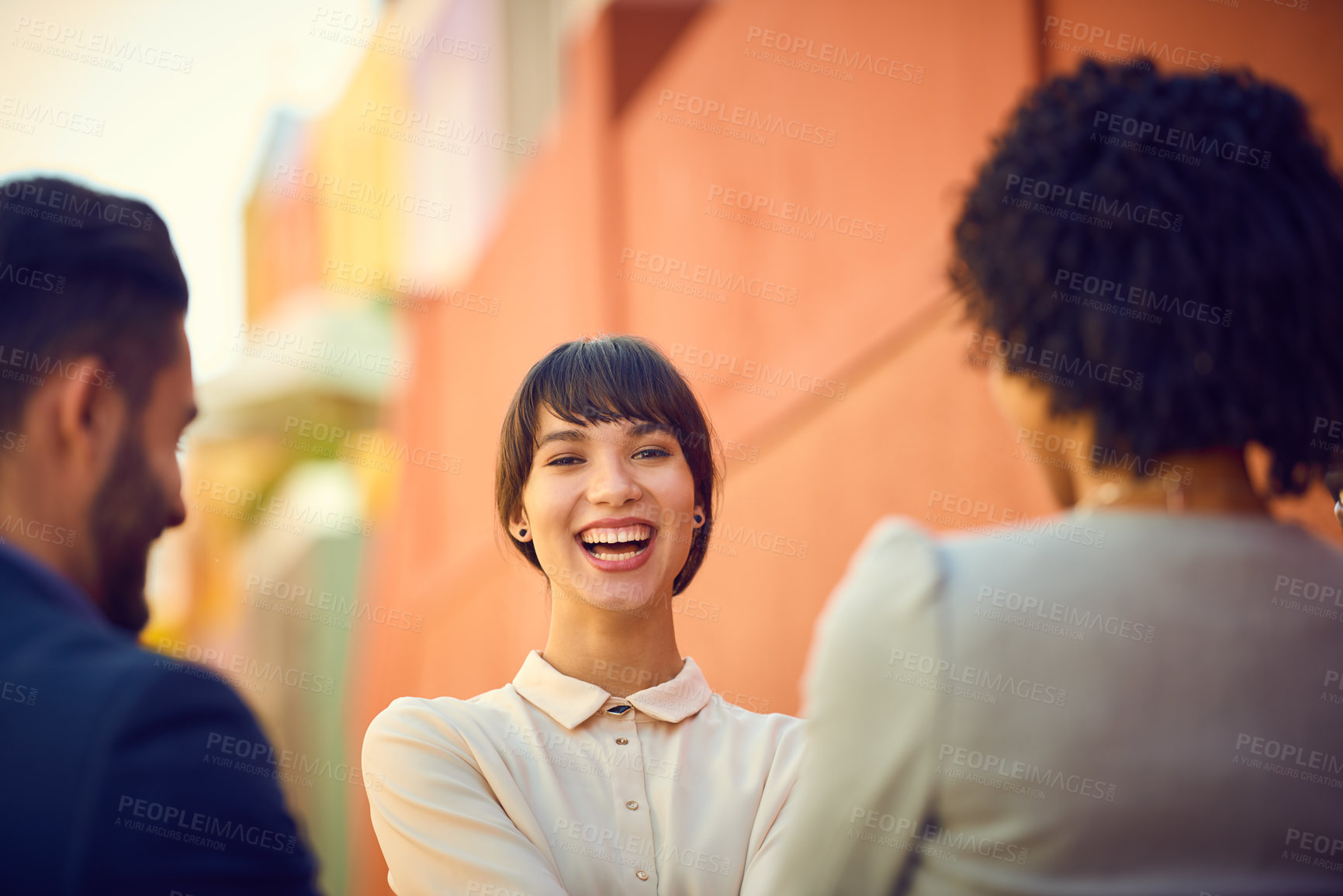 Buy stock photo Portrait of a young businesswoman standing with her colleagues outdoors