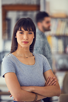 Buy stock photo Portrait of a confident young businesswoman with her colleagues working in the background of a modern office