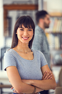 Buy stock photo Portrait of a confident young businesswoman with her colleagues working in the background of a modern office