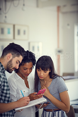 Buy stock photo Shot of a group of young businesspeople having an informal meeting in a modern office