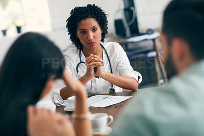 Buy stock photo Cropped shot of a couple meeting a doctor at her practice