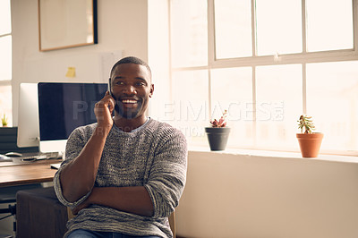 Buy stock photo Shot of a young businessman using a mobile phone at his desk in a modern office