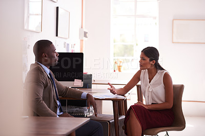 Buy stock photo Shot of two businesspeople having a discussion in an office