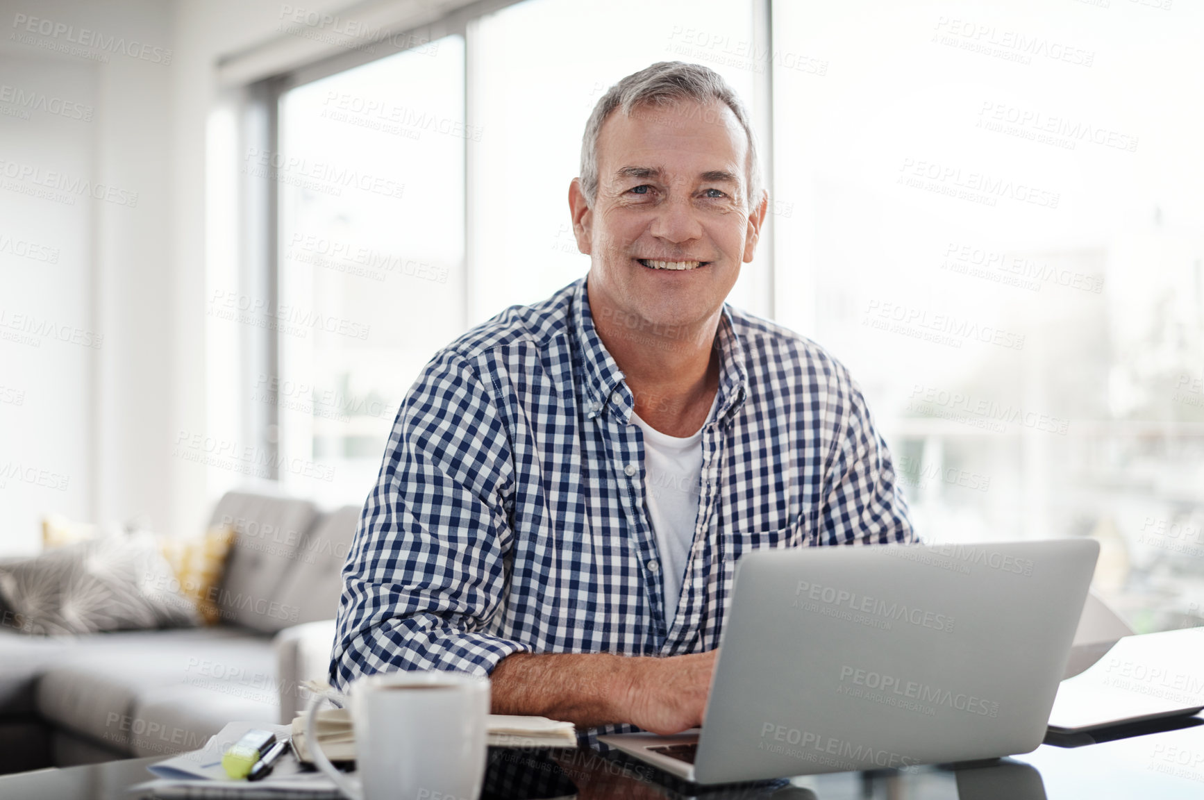 Buy stock photo Portrait of a mature man working on a laptop at home
