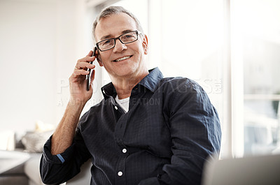 Buy stock photo Portrait of a mature man talking on a cellphone at home