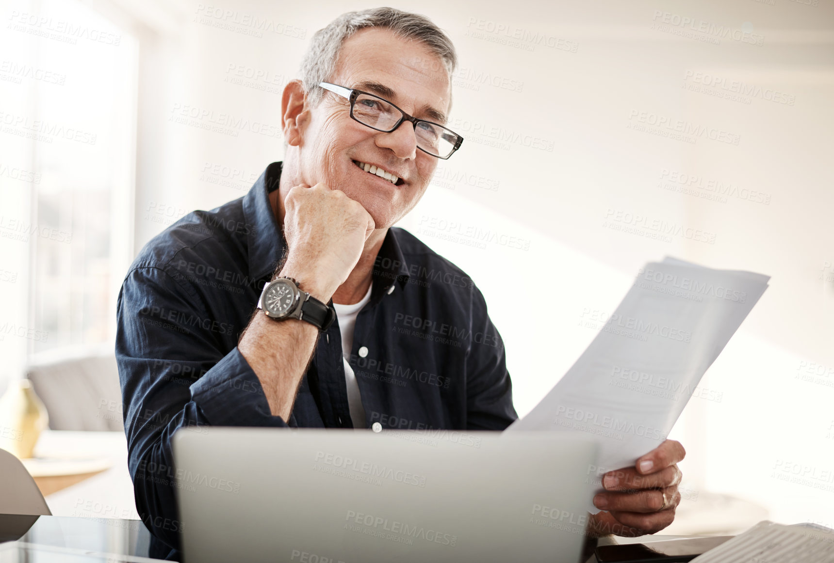 Buy stock photo Portrait of a mature man going through some paperwork at home
