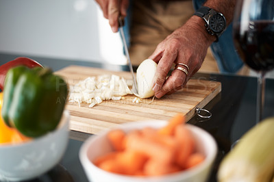 Buy stock photo Cropped shot of an unrecognizable man chopping onions on a cutting board