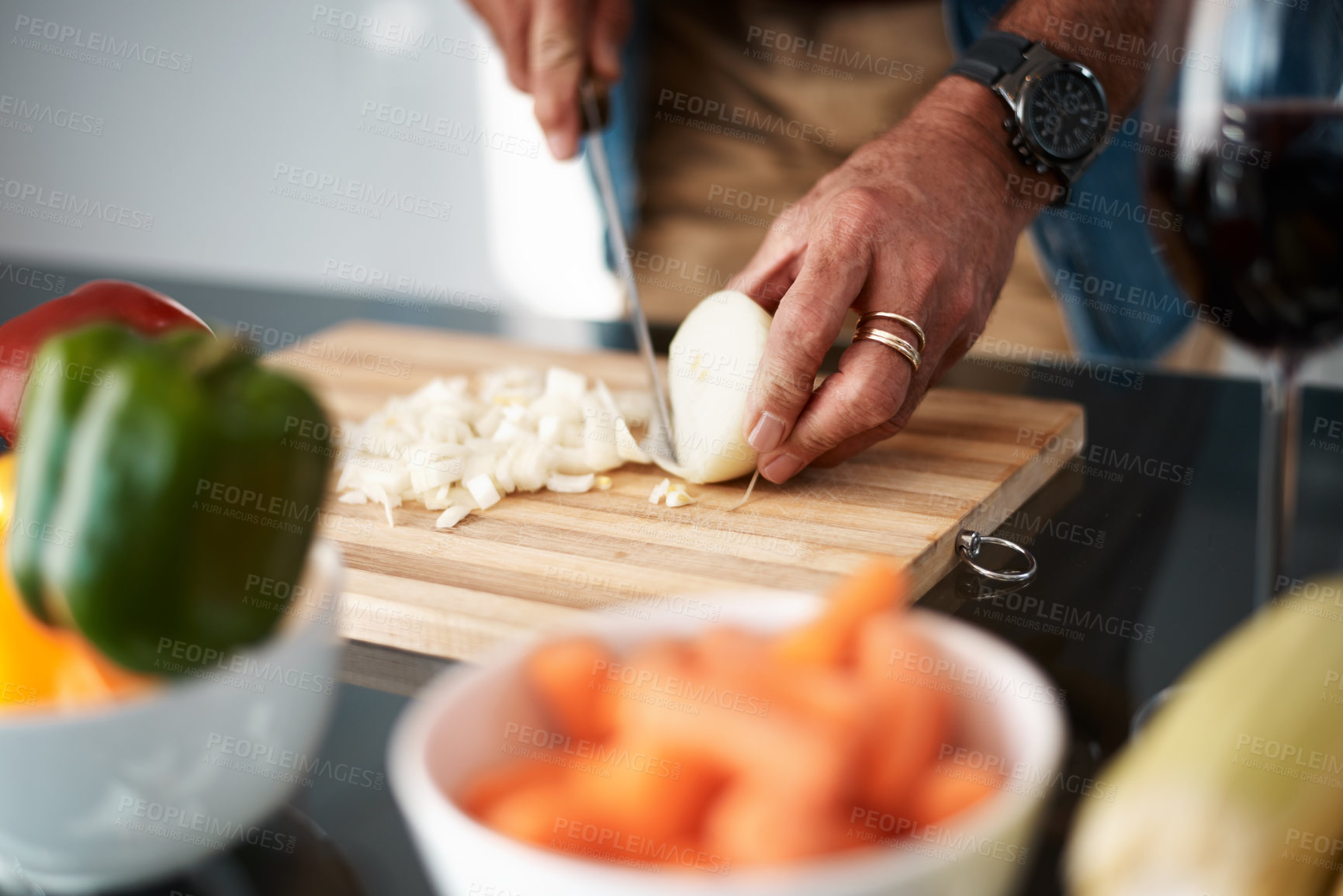 Buy stock photo Cropped shot of an unrecognizable man chopping onions on a cutting board