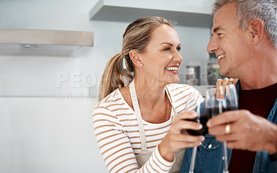 Buy stock photo Cropped shot of a mature couple enjoying a glass of wine at home