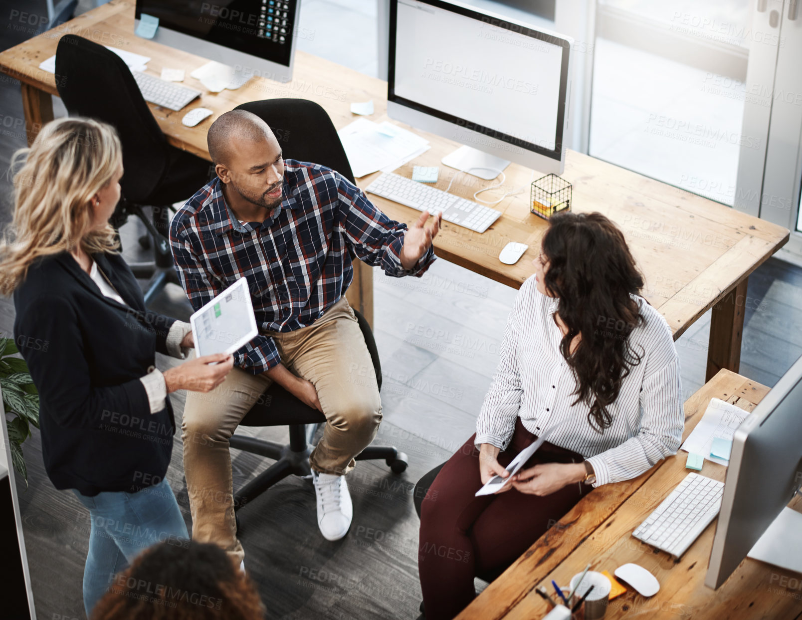 Buy stock photo High angle shot of a group of businesspeople having a discussion in an office