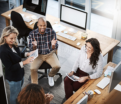 Buy stock photo High angle shot of a group of businesspeople having a discussion in an office