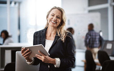 Buy stock photo Portrait of a mature businesswoman using a digital tablet in an office