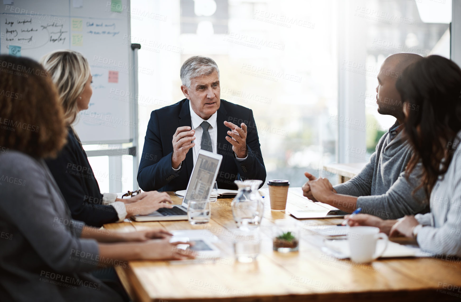 Buy stock photo Shot of a group of businesspeople having a meeting in an office