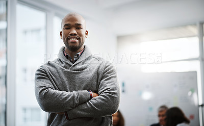 Buy stock photo Shot of a young businessman standing in an office