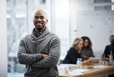 Buy stock photo Shot of a young businessman standing in an office