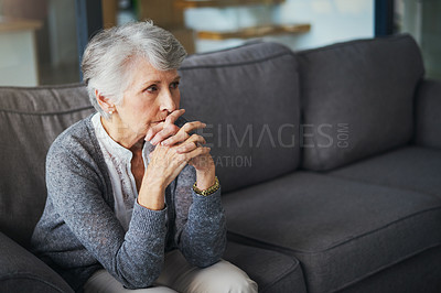 Buy stock photo Shot of a senior woman suffering from stress at home