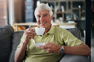 Buy stock photo Portrait of a senior man enjoying a beverage while relaxing on the sofa at home