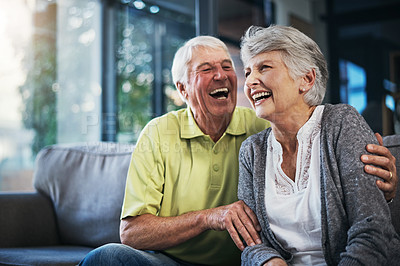 Buy stock photo Shot of a happy senior couple relaxing together on the sofa at home