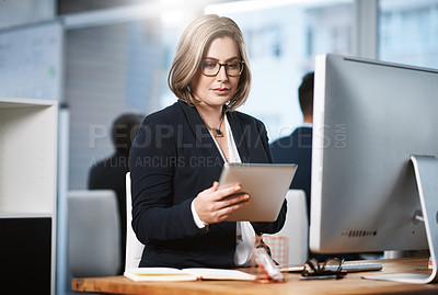 Buy stock photo Cropped shot of an attractive young businesswoman working at her desk in a modern office