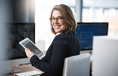 Buy stock photo Cropped portrait of an attractive young businesswoman working at her desk in a modern office